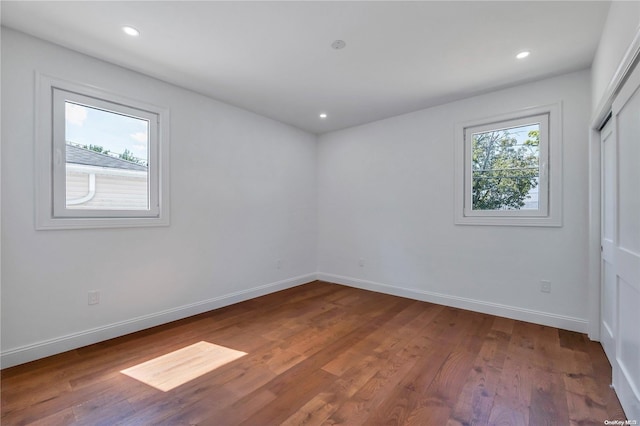 spare room with wood-type flooring