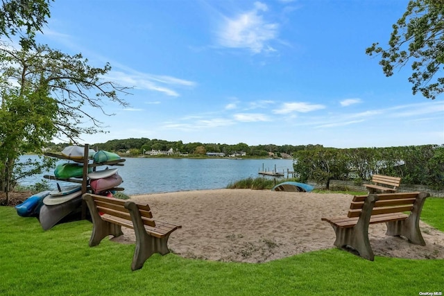 view of home's community featuring a lawn and a water view