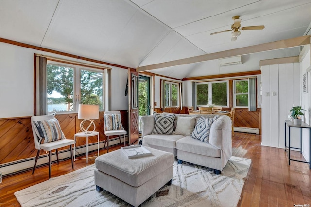 living room with hardwood / wood-style flooring, a wealth of natural light, and lofted ceiling