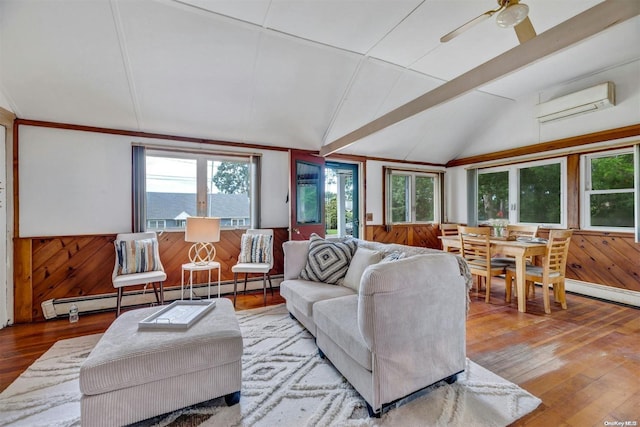 living room with a wall mounted air conditioner, hardwood / wood-style floors, lofted ceiling, wooden walls, and a baseboard radiator