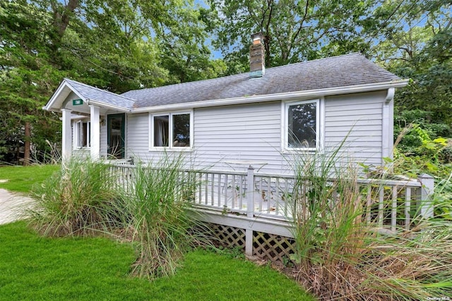 exterior space featuring a wooden deck and a yard