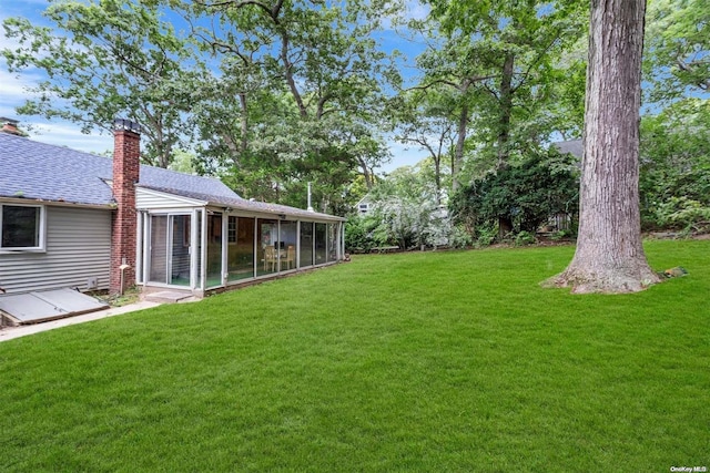 view of yard with a sunroom