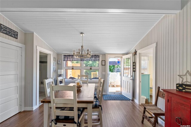 29 Ocean Rd, Ocean Beach, NY 11770 - dining room featuring ornamental molding, dark wood-type flooring, and a notable chandelier