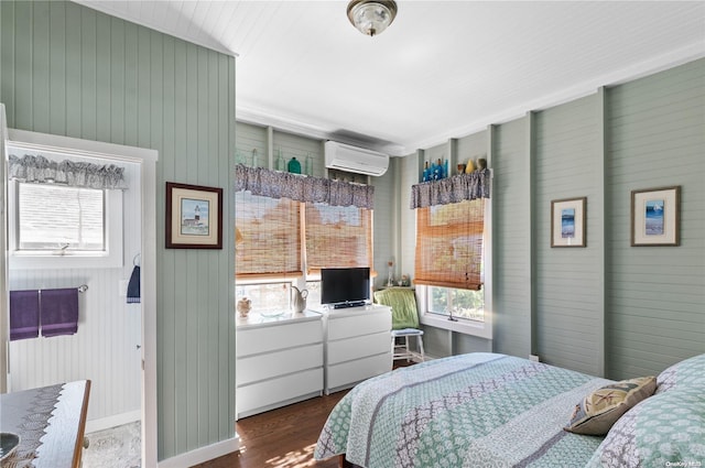 29 Ocean Rd, Ocean Beach, NY 11770 - bedroom with a wall mounted air conditioner, hardwood / wood-style flooring, and wooden walls