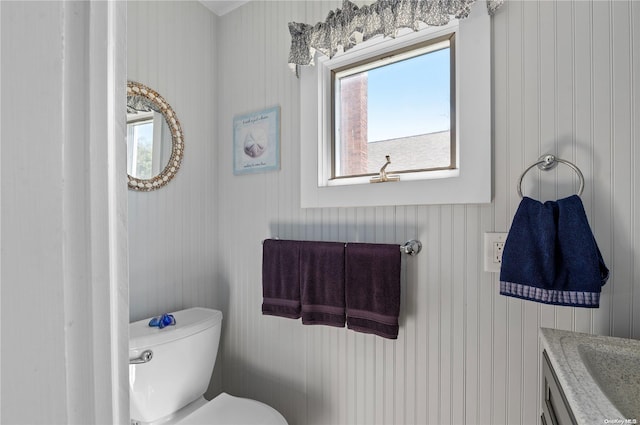29 Ocean Rd, Ocean Beach, NY 11770 - bathroom featuring vanity, toilet, and wood walls