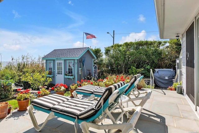 view of patio / terrace featuring an outbuilding