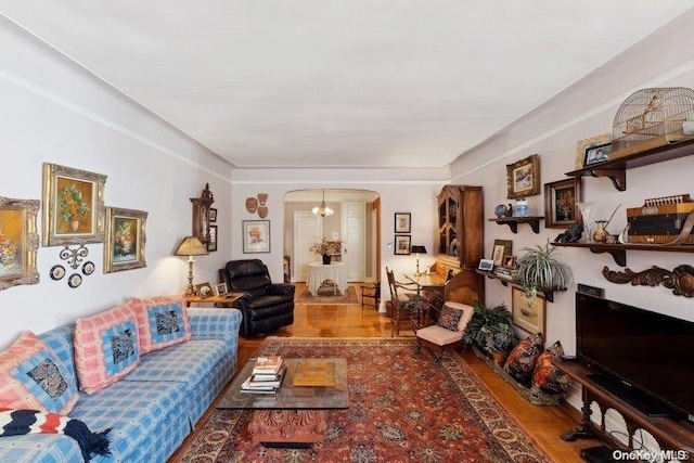 living room with wood-type flooring and an inviting chandelier