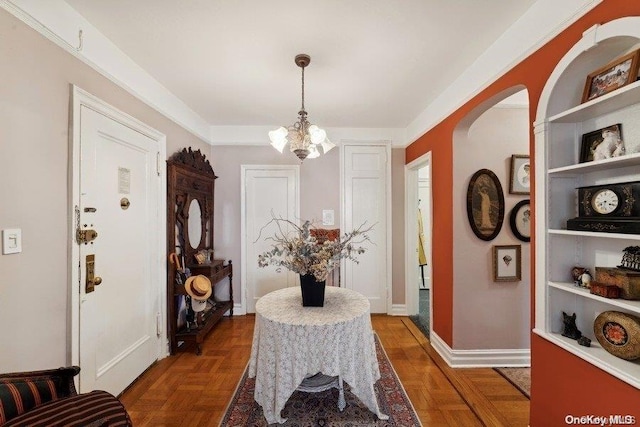 interior space featuring dark parquet floors and an inviting chandelier