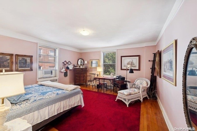 bedroom featuring crown molding, cooling unit, and hardwood / wood-style flooring