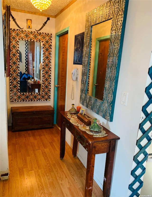 hallway featuring hardwood / wood-style floors and a textured ceiling