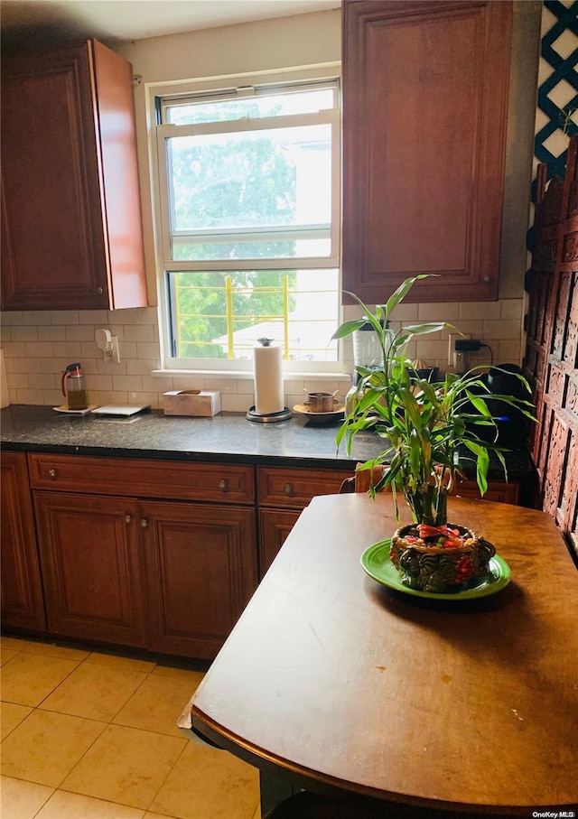 kitchen with light tile patterned flooring and backsplash