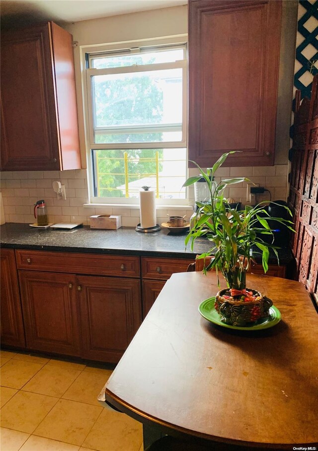 12-28 150th St, Whitestone, NY 11357 - kitchen with decorative backsplash, plenty of natural light, and light tile patterned flooring