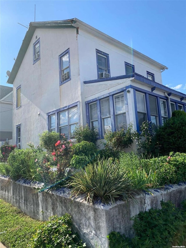 12-28 150th St, Whitestone, NY 11357 - view of property exterior featuring stucco siding and cooling unit