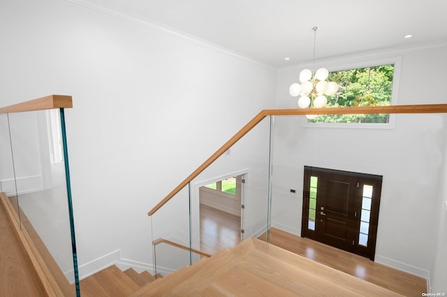 entryway featuring a chandelier, light hardwood / wood-style flooring, and a healthy amount of sunlight