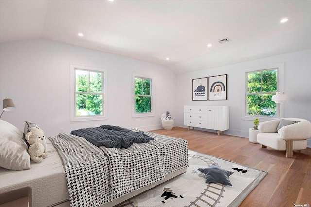 bedroom featuring hardwood / wood-style floors and vaulted ceiling