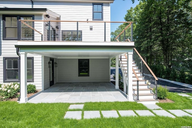 back of house featuring a balcony and a patio area