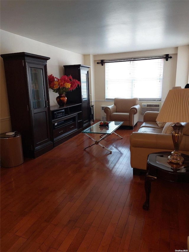 living room with a wall mounted AC and dark hardwood / wood-style floors