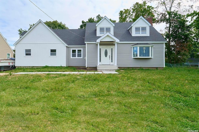 cape cod home with a front lawn