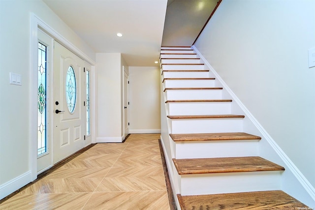 foyer entrance featuring light parquet flooring and plenty of natural light