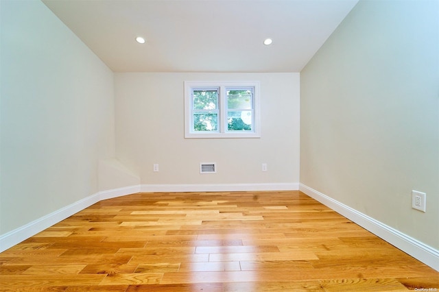 empty room with light hardwood / wood-style flooring