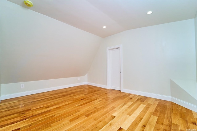 interior space featuring light hardwood / wood-style floors and vaulted ceiling