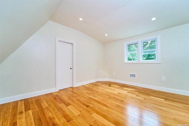 bonus room featuring light hardwood / wood-style flooring and vaulted ceiling