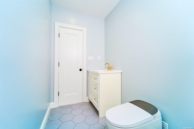 bathroom with tile patterned floors, vanity, and toilet