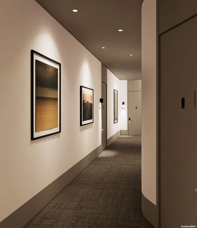 hallway with dark carpet