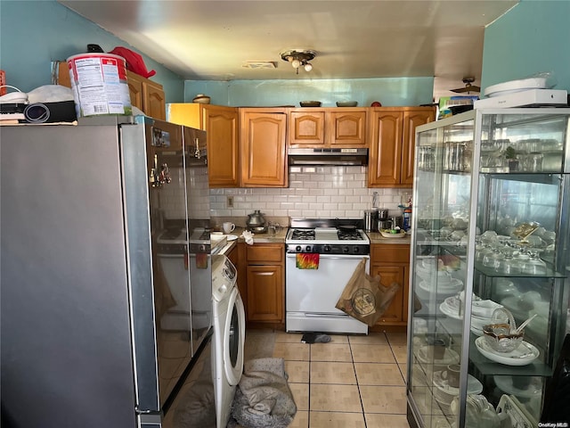 kitchen featuring washer / clothes dryer, stainless steel fridge, fridge, white range with gas cooktop, and decorative backsplash