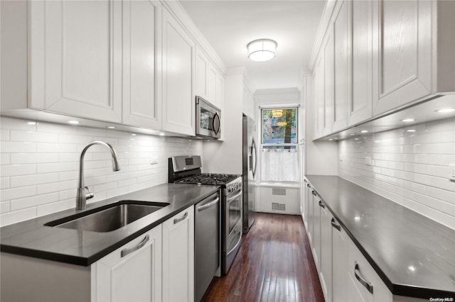 kitchen featuring white cabinets, appliances with stainless steel finishes, and sink