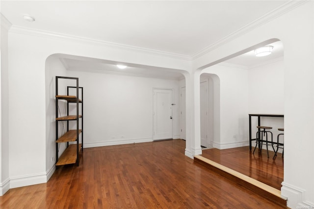 spare room featuring hardwood / wood-style flooring and ornamental molding