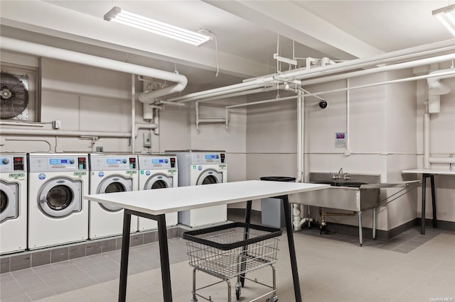 clothes washing area featuring separate washer and dryer and sink