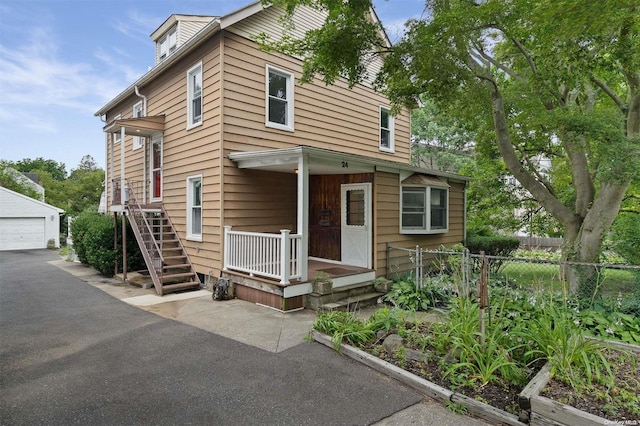24 Kellogg St, Oyster Bay, NY 11771 - view of front of property featuring an outdoor structure and a detached garage