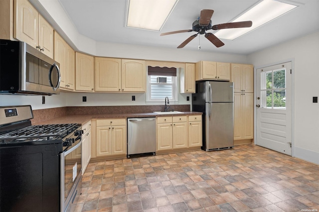 kitchen with stainless steel appliances, ceiling fan, and sink