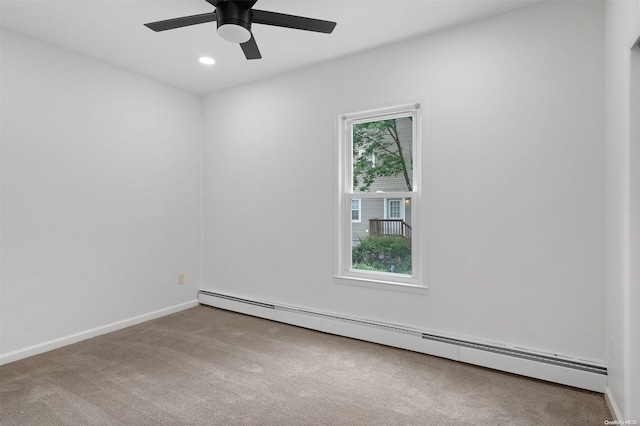 empty room with carpet flooring, ceiling fan, and a baseboard radiator