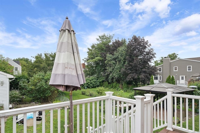 wooden terrace with a lawn