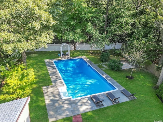 view of swimming pool with a patio area and a lawn