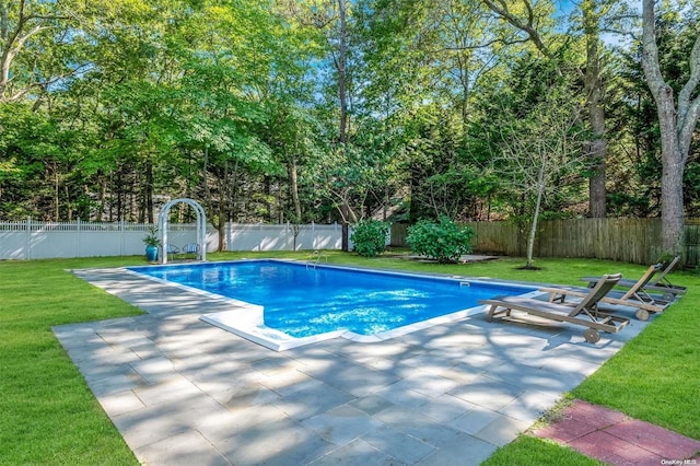 view of swimming pool with a yard and a patio area