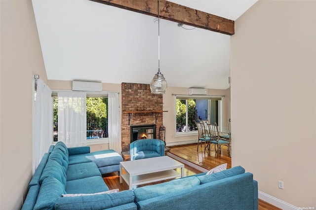 living room with high vaulted ceiling, a brick fireplace, hardwood / wood-style flooring, beam ceiling, and a wall unit AC