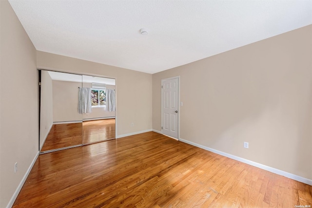 unfurnished room with hardwood / wood-style floors