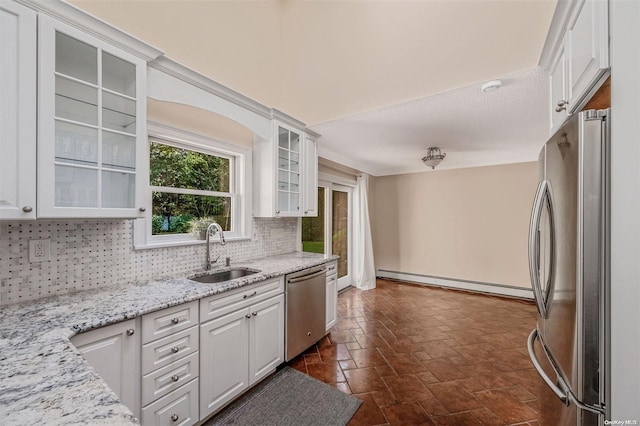 kitchen featuring white cabinets, stainless steel appliances, a baseboard radiator, and sink