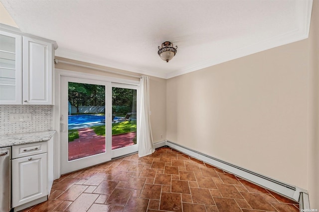 interior space featuring ornamental molding and a baseboard heating unit