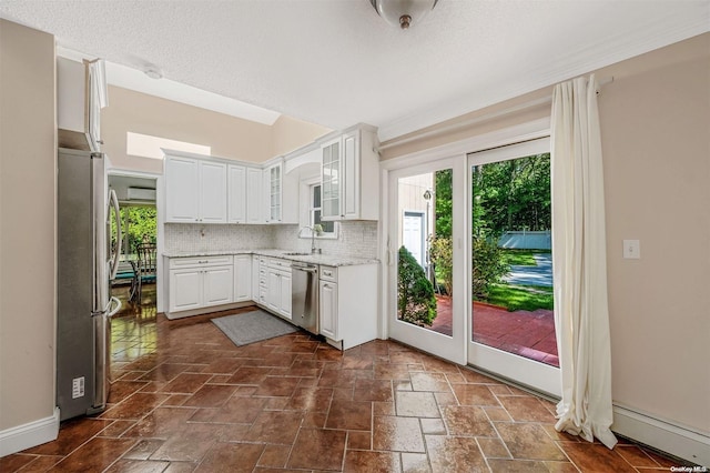 kitchen with white cabinets, sink, backsplash, and appliances with stainless steel finishes