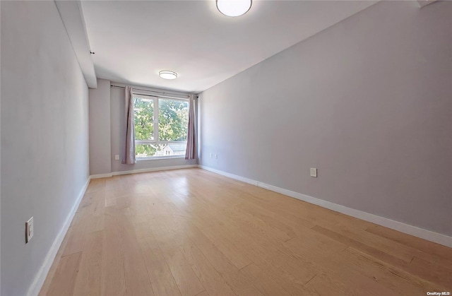 spare room with light hardwood / wood-style floors