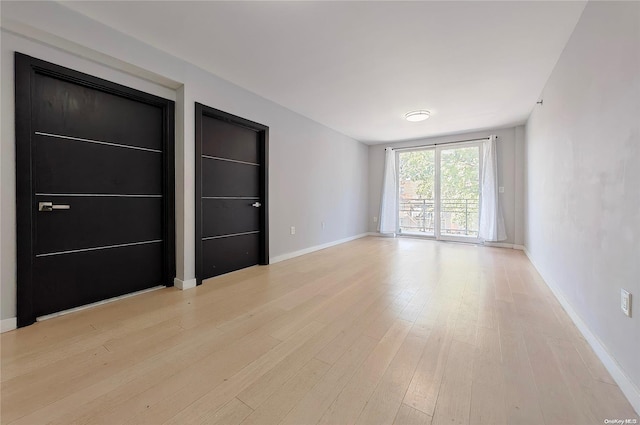 unfurnished room with light hardwood / wood-style flooring