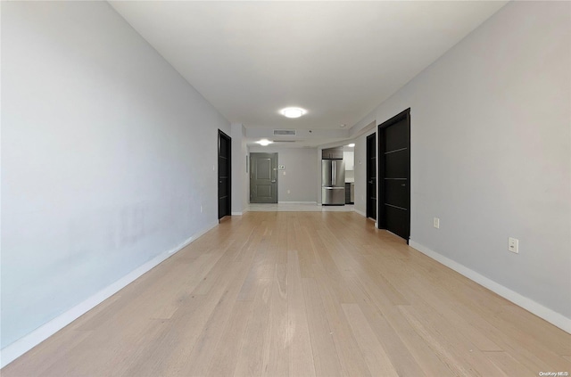 unfurnished room with light wood-type flooring