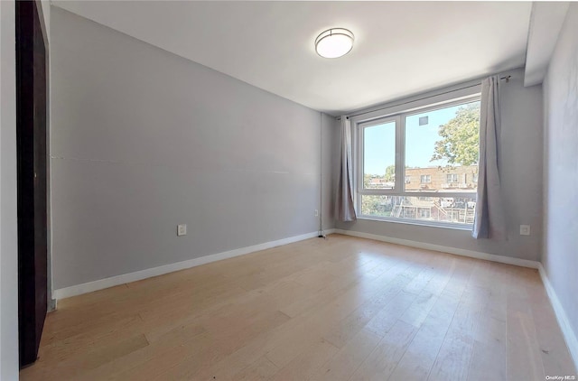 spare room featuring light wood-type flooring