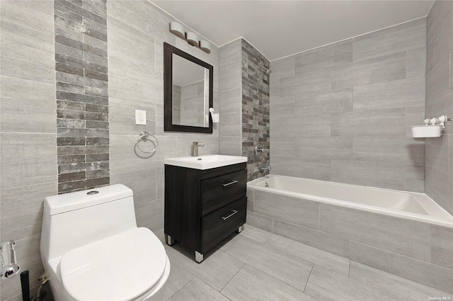 bathroom with tile patterned floors, vanity, tile walls, and toilet