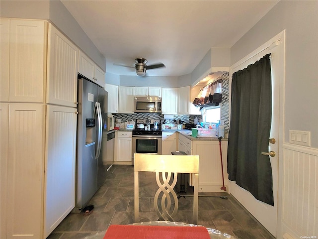 kitchen featuring backsplash, ceiling fan, white cabinetry, and stainless steel appliances