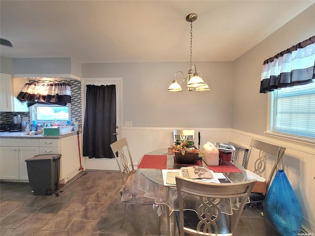 dining room featuring a wealth of natural light and a chandelier